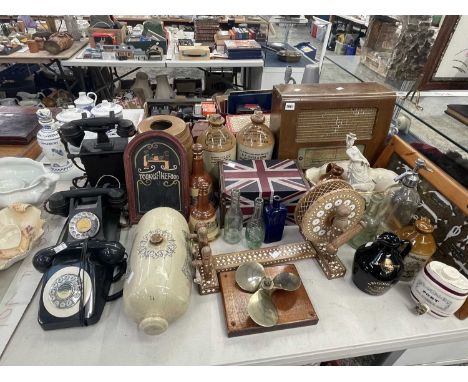 Three vintage telephone sets, stoneware jars and flasks, a radio, a wool winder, a propellor, etc