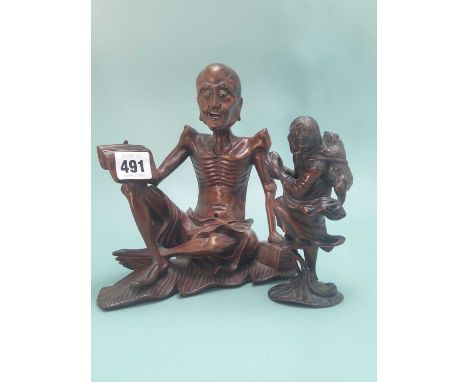 A Chinese carved wood figure of Liu Hai standing on a lotus leaf with his familiar toad strapped to his back.   H 14cms. toge