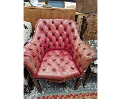 A button leather upholstered armchair.