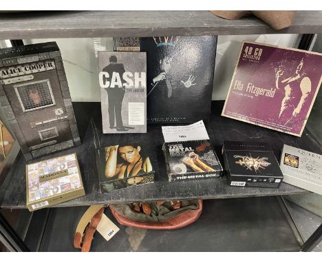 A collection of CD box sets: Elvis, Johnny Cash, Alice Cooper, Ella Fitzgerald, Rihanna, etc.