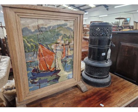 A vintage Valour parafin heater and a firescreen.