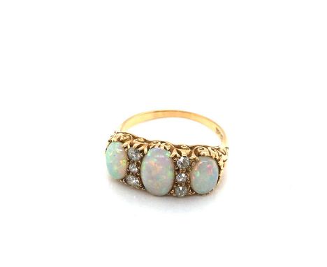 A vintage 18ct gold stamped opal and diamond carved half hoop ring. Ring size P. Weight 4.56 grams.