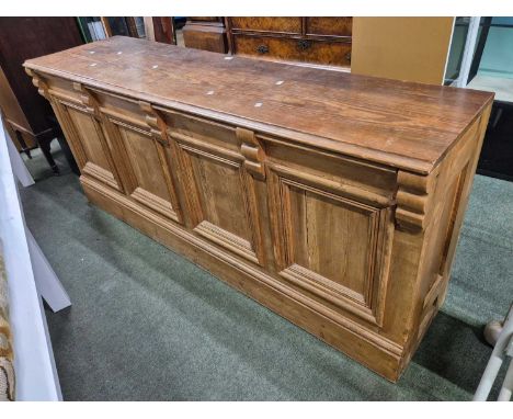 A pine shop counter with three drawers over an open shelf to one side and four panels to the other.   W 190 x D 51 x H 81cms.