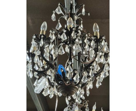A cast metal and glass nine light chandelier