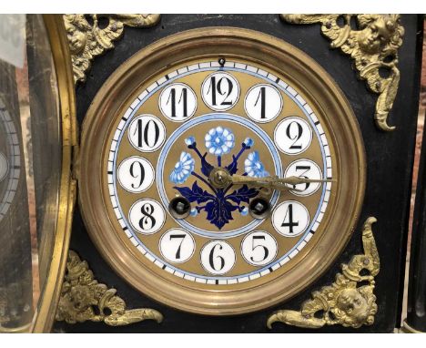 A Victorian aesthetic movement mantle clock in an ebonised wood case mounted with brass and enamelled decorations ( for a nea