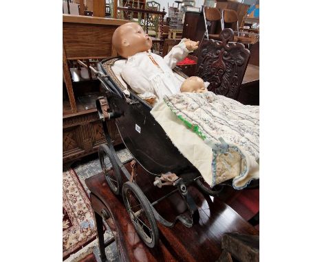 A vintage dolls pram and Two dolls.