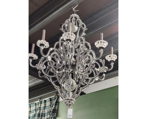 A glass and metal nine-arm chandelier. Drop 1100, Diameter 750 cms. 