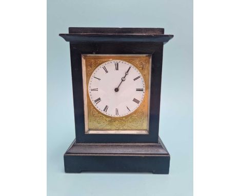 A 19th-century small ebonised case mantle or desk clock. the white dial within a decorative gilt border. 8 day Brevette movem