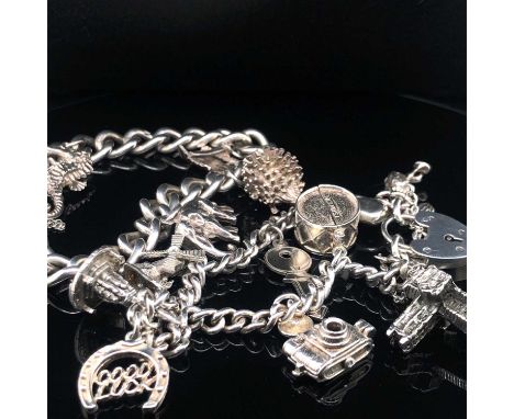 Two vintage silver charm bracelets with attached charms to include Banbury Cross. Gross weight 75.68 grams.