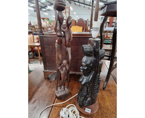 Two carved hardwood african figures together with a mantle clock and a barometer