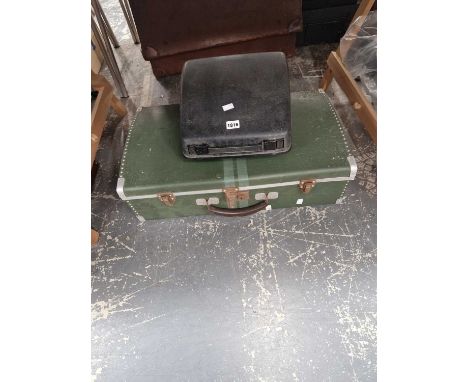 A cased typewriter together with an aluminium suitcase