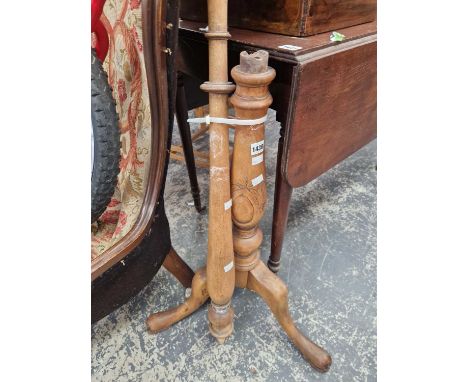 A tripod base wooden standard lamp