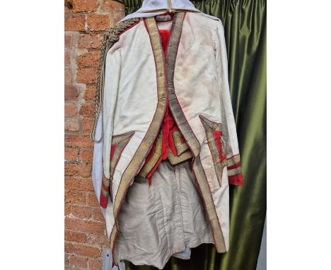 Two antique White Felt Postillion uniforms with gilt and red trimmings, red velvet britches together with a similar overcoat 