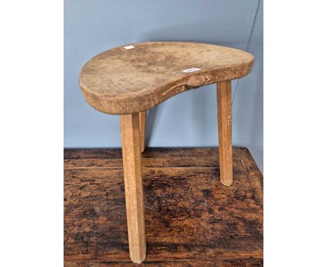 A Robert 'Mouseman' Thompson oak stool on three facetted legs