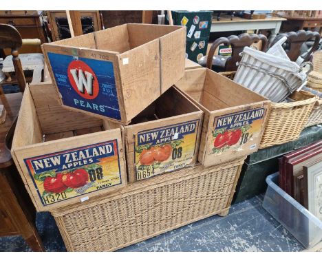 Various apple crates, wicker baskets and a tin trunk.
