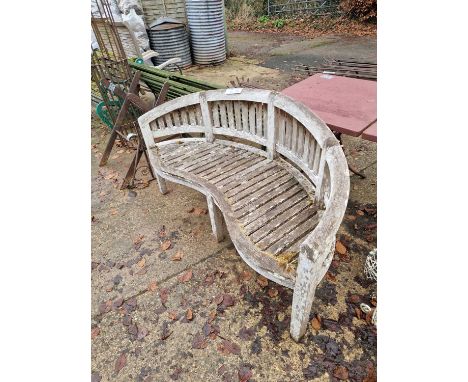 A good quality teak garden bench with curved back
