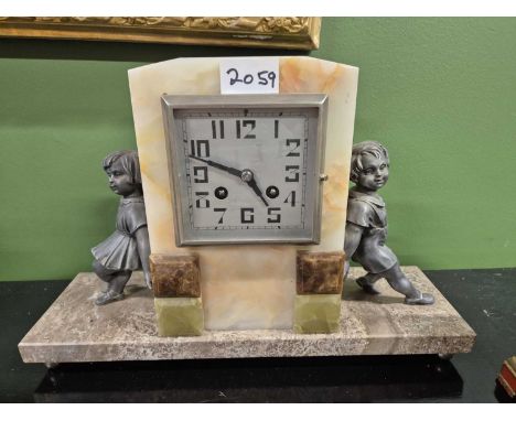A marble and agate mounted mantel clock flanked by spelter figures of a girl and a boy and together with a red chinoiserie ma