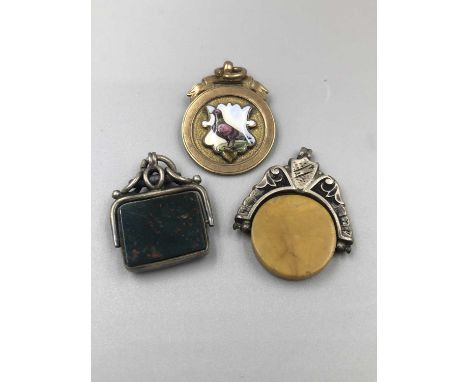 A vintage 9ct hallmarked gold and enamel fob pendant, and two silver examples. 9ct weight 8.47 grams. 