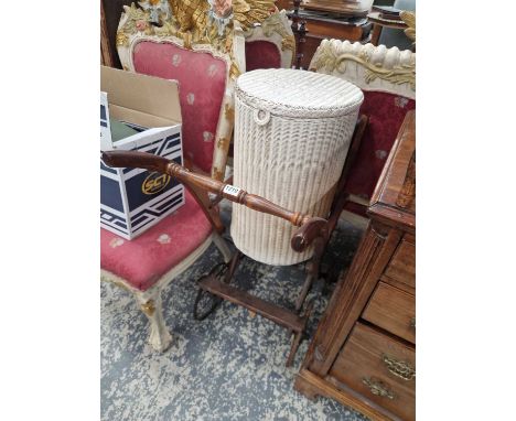An antique wooden push chair and a lloyd loom basket.