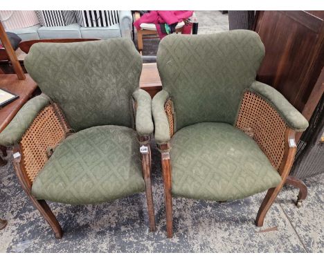 A pair of vintage bergere armchairs.