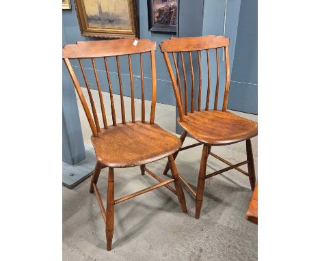 A set of eight American stick-back chairs, each with broad top rails with stepped corners, the saddle seats on turned legs. S