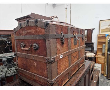 A vintage wood slatted dome top cabin trunk.