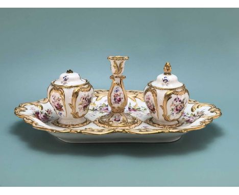 Attributed to Coalport, a 19th century floral painted inkstand, the two covered inkwells flanking a taper stick on the salmon
