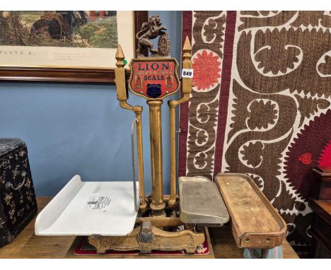 A set of Herbert &amp; Sons gilt metal 'Lion' scales named on a red ground at the top of the central lion topped column, the 