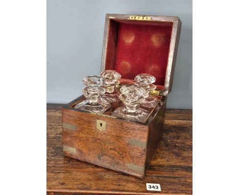 A brass bound rosewood decanter box containing four spirit decanters. H 23 W 22 D22cms