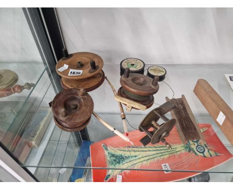 Three wooden fishing reels, another in brass, two quill floats together with some line