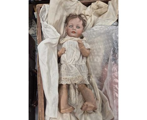 Three German bisque doll's heads with body parts for restringing together with some clothing