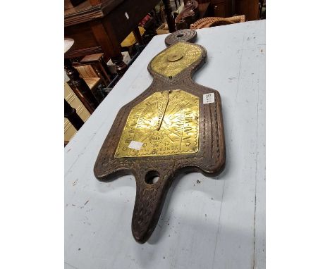 A 17th century style carved oak and brass sundial.
