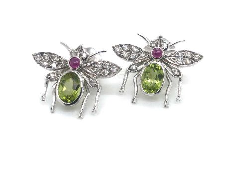 A pair of insect-form stud earrings. Each insect is set with an oval peridot, cabochon ruby and diamond set wings. Peridot 1.