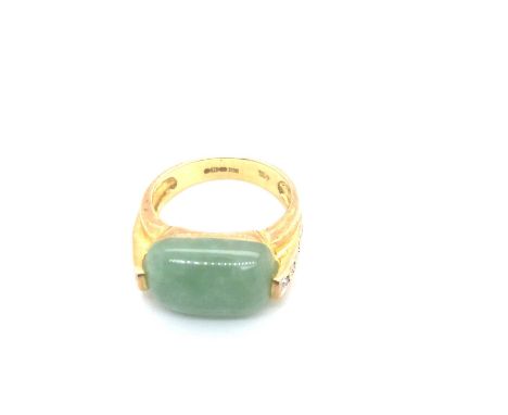 A 9ct hallmarked gold jade and diamond set dress ring. Ring size M. Weight 4.42 grams. 