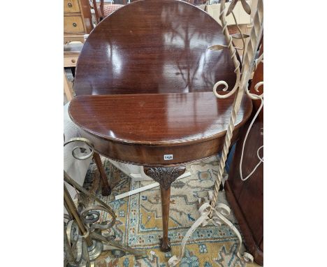 An early 20th-century Georgian style demi-lune fold over card table.