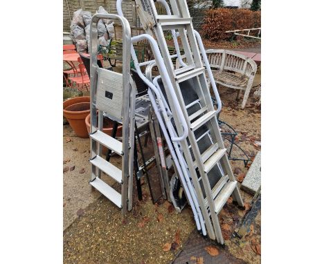 A collection of various aluminium ladders, step ladders, work bench etc.