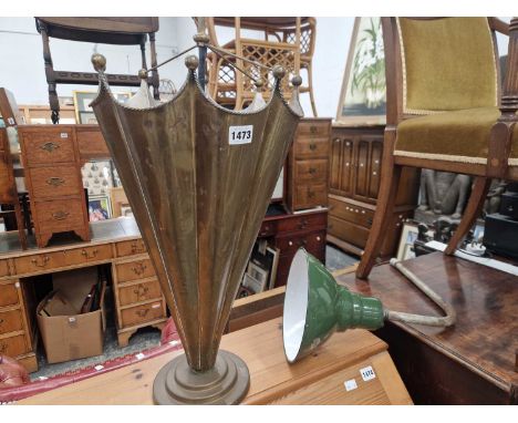 A brass umbrella form stick stand and an enamel light fitting.