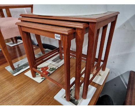 A retro nest of teak tile topped tables