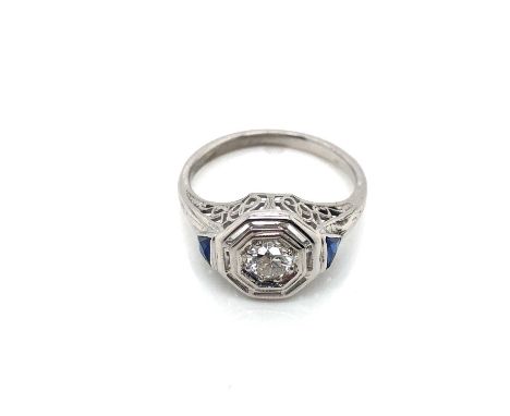 A vintage diamond and sapphire ring. The old European cut diamond centre measuring approximately 4.00 mm diameter approx dept