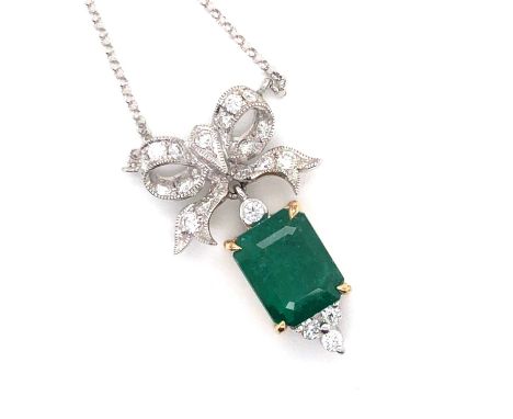 An emerald and diamond Victorian-style pendant necklace. The central step-cut emerald set above and below with diamonds and s