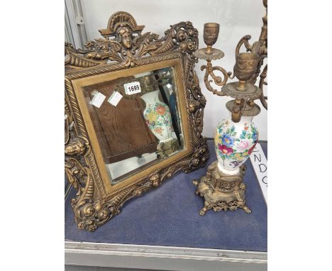 An easel backed brass framed mirror together with an ormolu five light candelabrum on a floral porcelain vase column