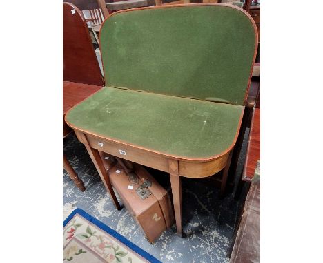 A Regency mahogany and boxwood strung d-form foldover card table on square legs with spade feet.