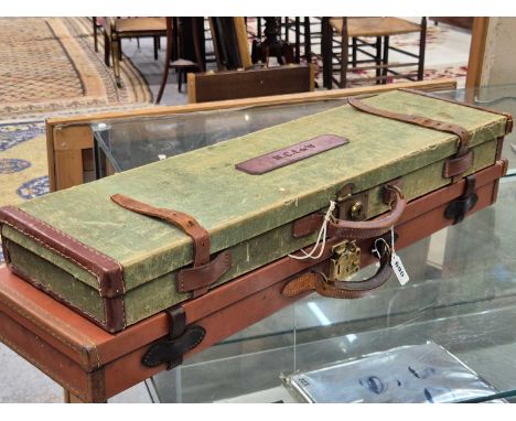 A vintage Canvas and leather shotgun case and a similar case in brown leatherette. both cases contain cleaning rods.