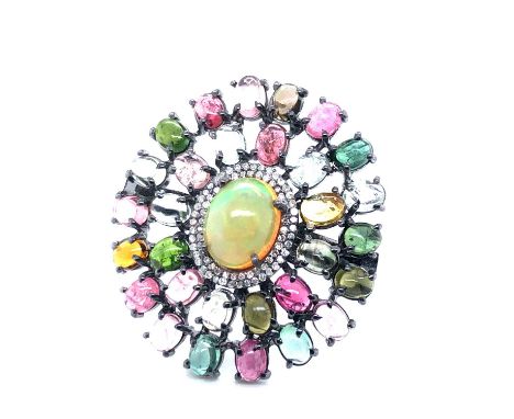 A large multi-cluster gemset ring. Multi-coloured cabochon tourmalines and a double halo of diamonds surround the central ova