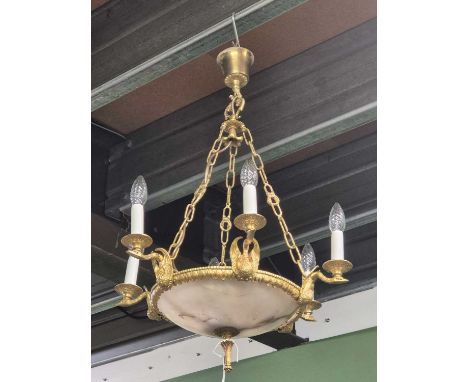 A gilt metal and alabaster six arm chandelier. H 82cms Diameter 55cms