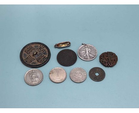A 1934 American half dollar pendant, a 1988 Swiss 2 franc coin, Singapore and Hong Kong 'silver' coins, a Turkish copper coin