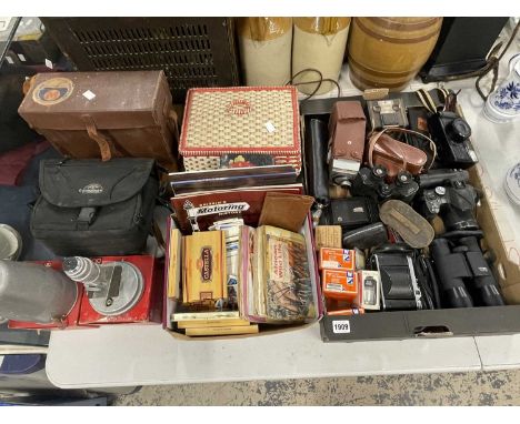 Cameras, binoculars, a microscope, a sewing basket, cigarette cards, etc.