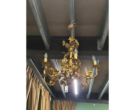 A gilt tolware six arm chandelier