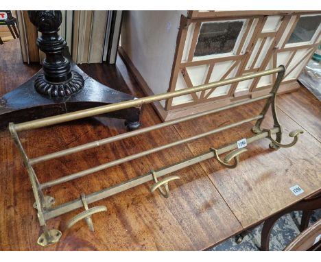 A vintage brass coat and hat rail.