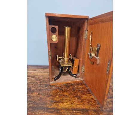 A mahogany cased brass barreled microscope with some accessories